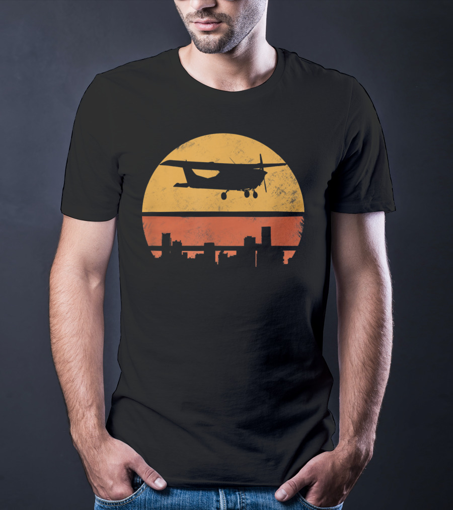 Retro Pilot C172 Flying Silhouette Over Sunset Cityscape T-Shirt
