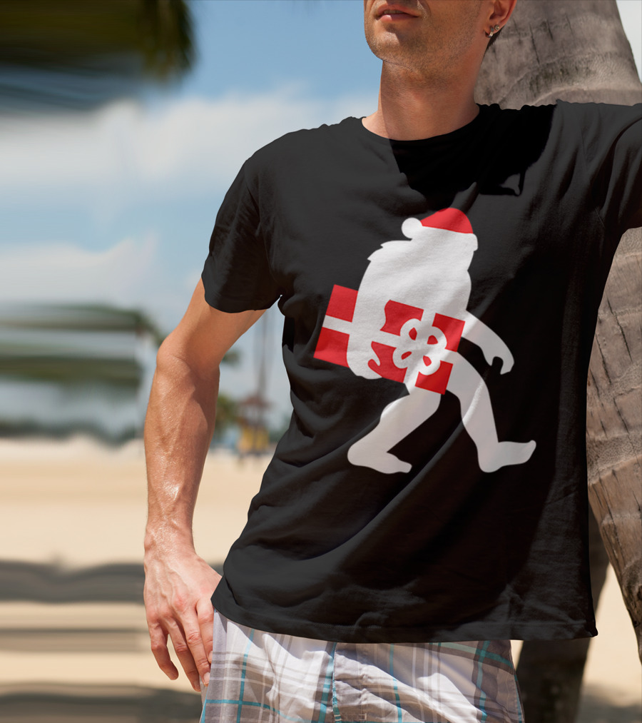 Nice Bigfoot Carrying Christmas Gift In Santa Hat T-Shirt