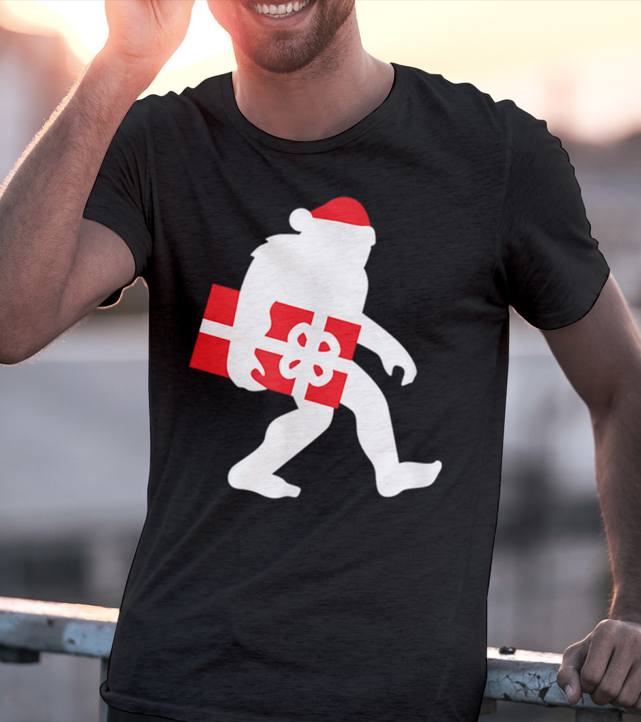 Nice Bigfoot Carrying Christmas Gift In Santa Hat T-Shirt