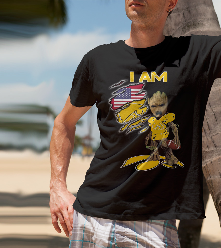 I Am Hawkeyes Baby Groot Holding Football With Usa Flag And Iowa Hawkeyes T-Shirt