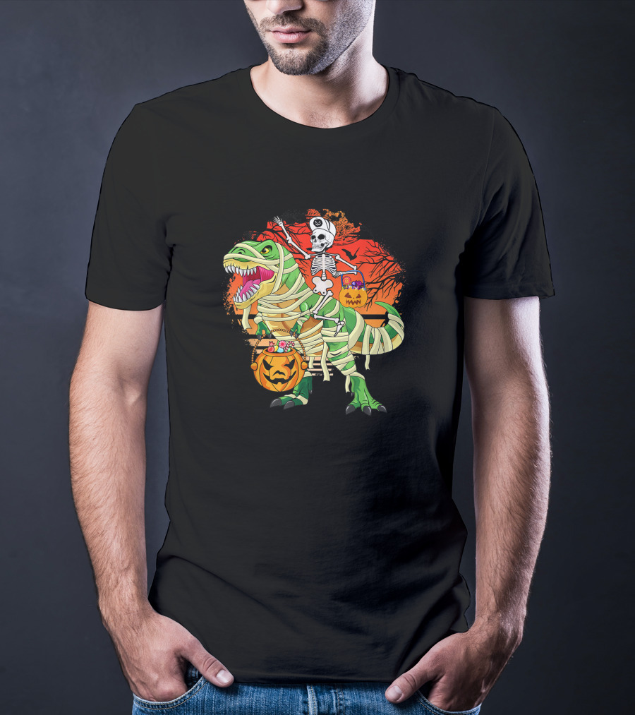 Skeleton Riding Mummy Dinosaur Rex With Halloween Pumpkins On Spooky Background T-Shirt