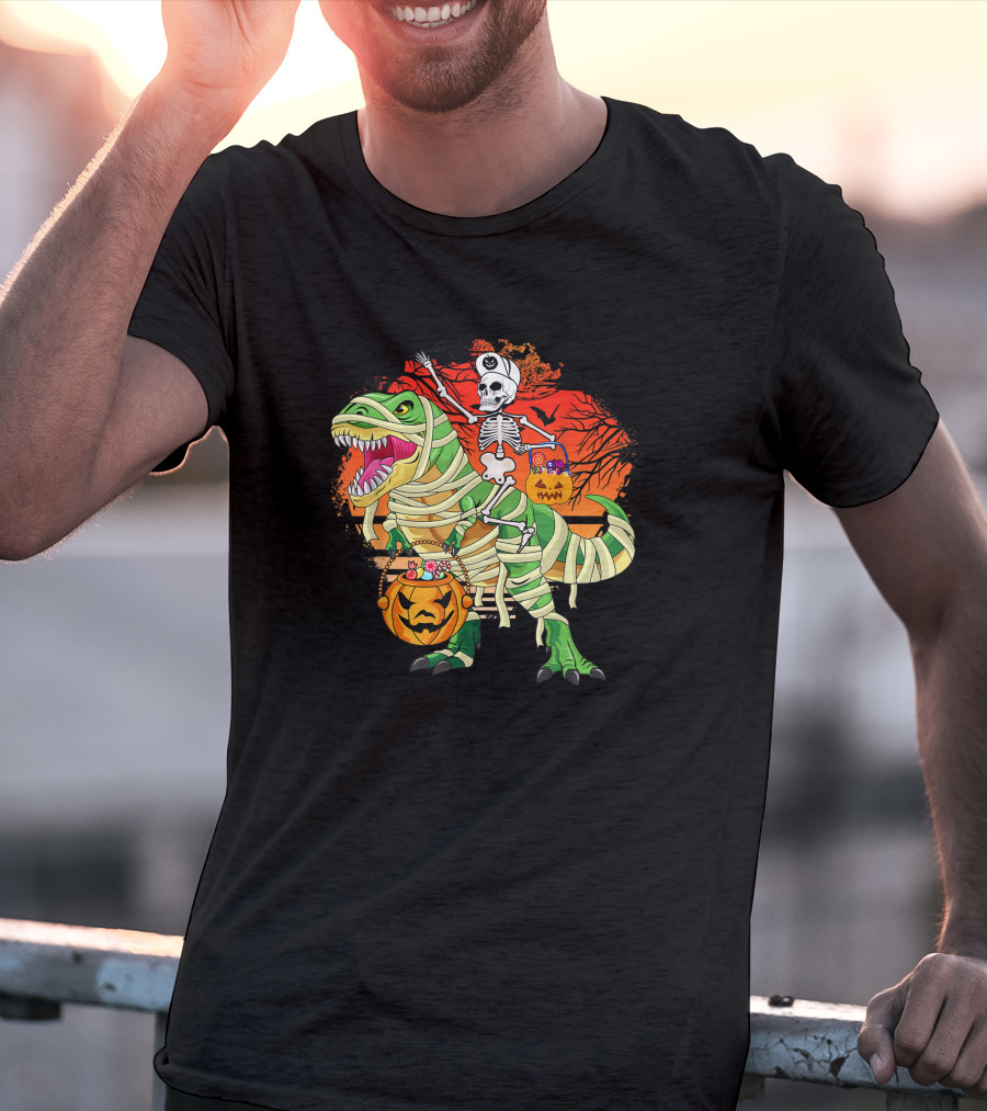 Skeleton Riding Mummy Dinosaur Rex With Halloween Pumpkins On Spooky Background T-Shirt