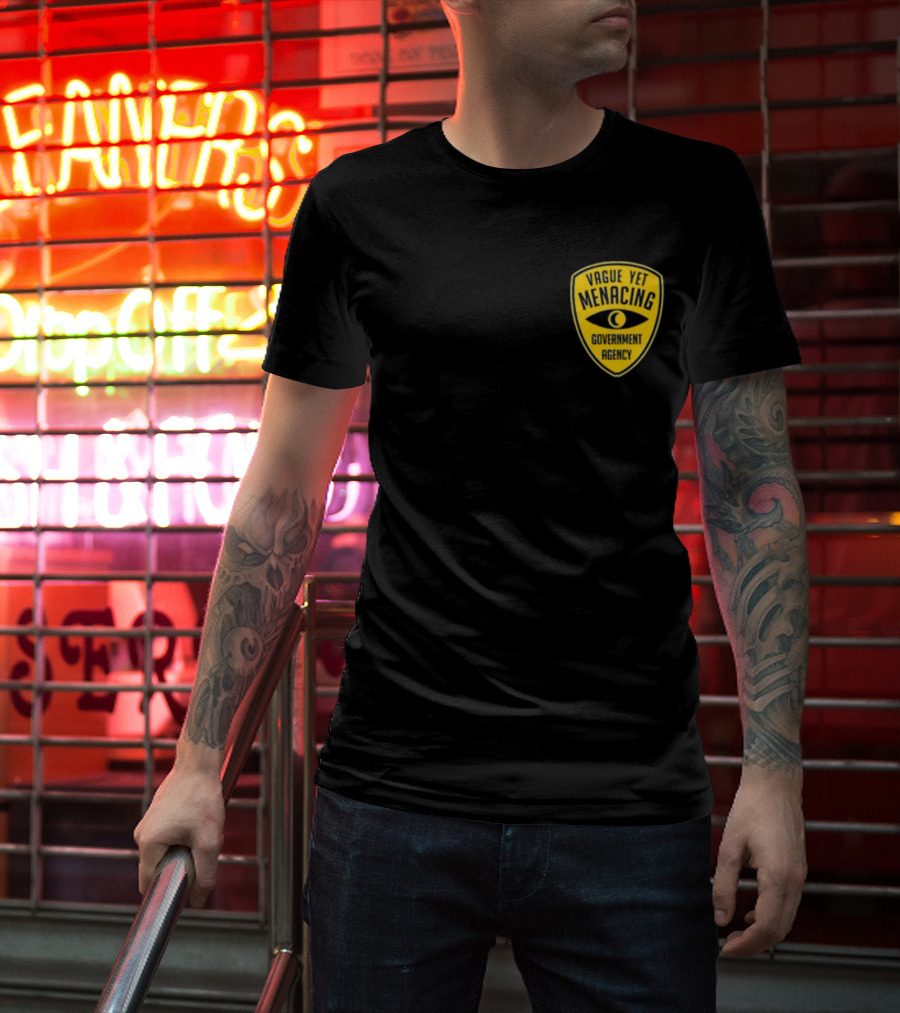 Vague Yet Menacing Government Agency Yellow Badge With Eye T-Shirt