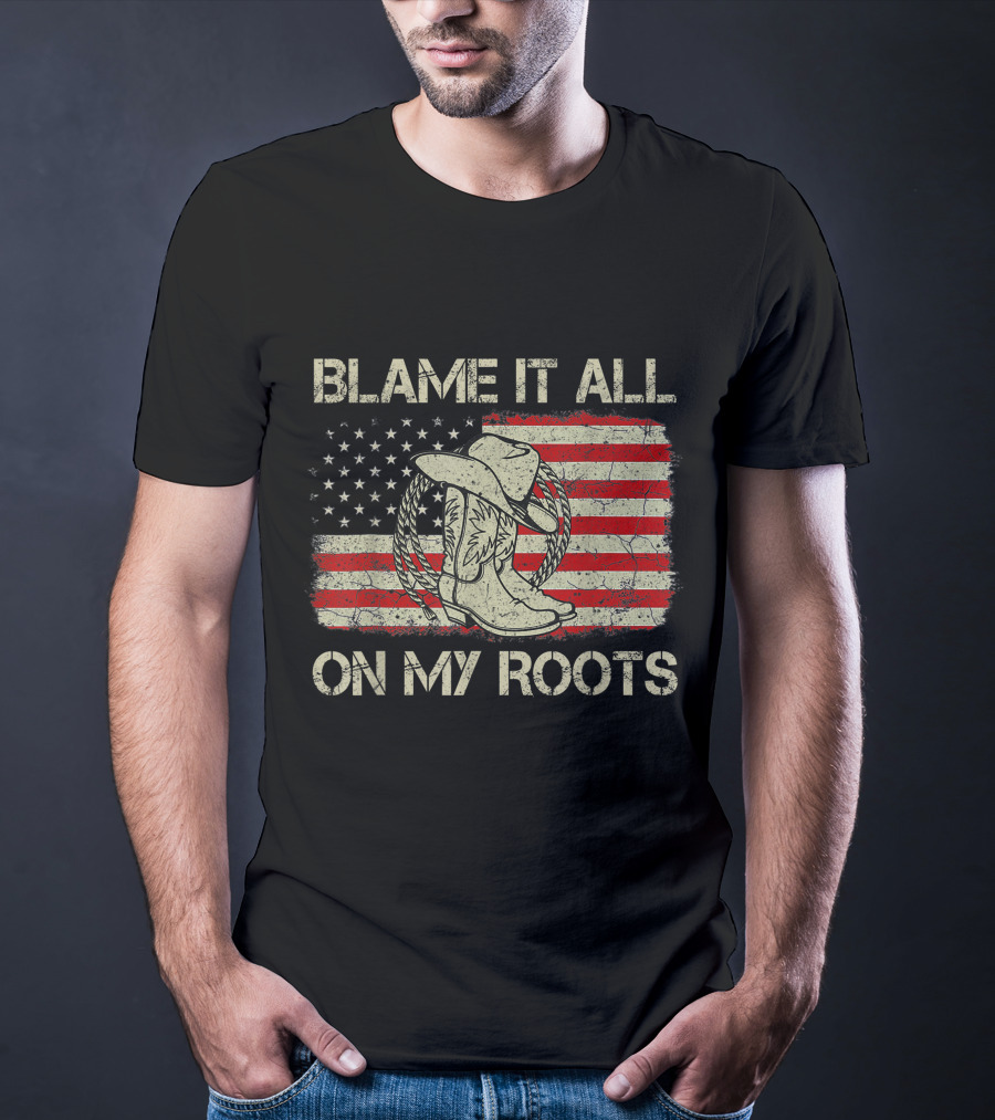Blame It All On My Roots Cowboy Hat Boots American Flag Background T-Shirt