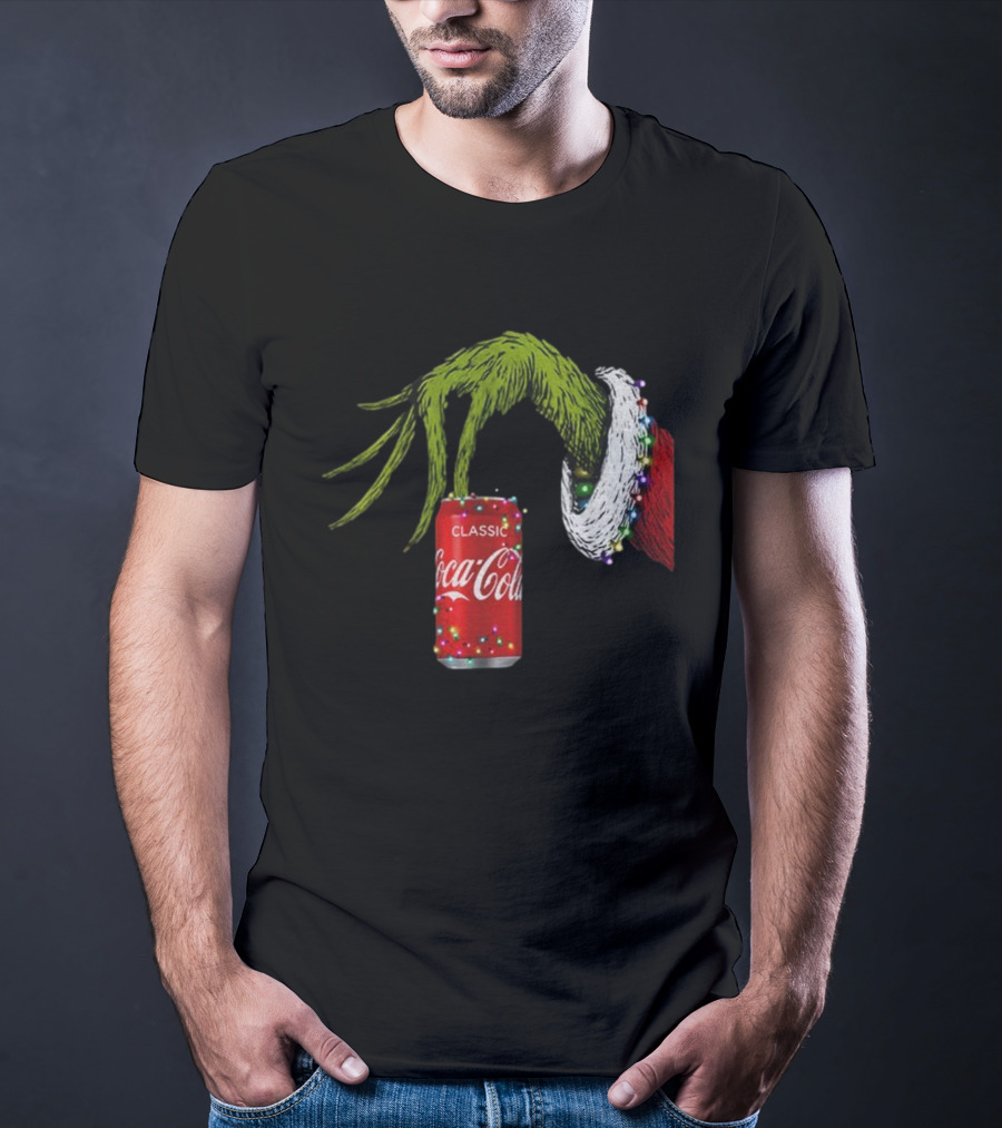 Grinch Hand Holding Coca-Cola Can Wrapped In Christmas Lights Merry Christmas T-Shirt