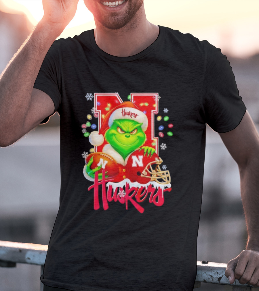 Grinch Santa With Nebraska Cornhuskers Helmet And Football Merry Christmas Huskers T-Shirt