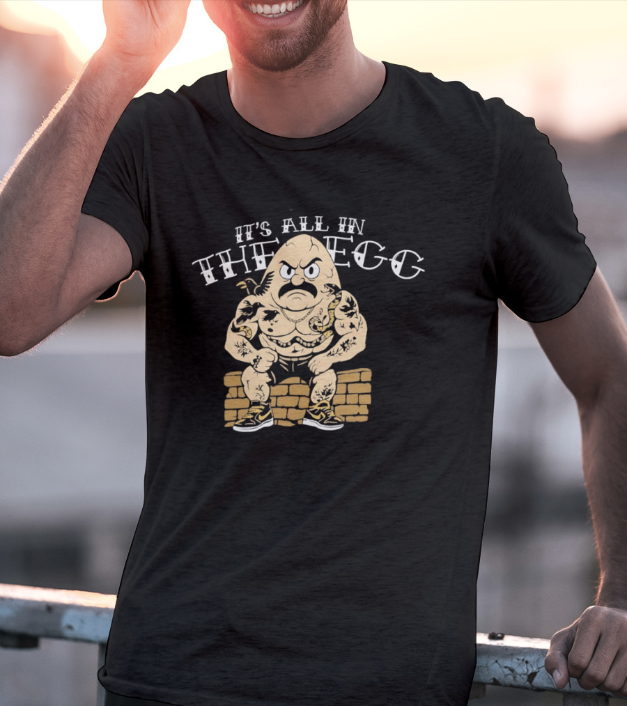It's All In The Egg Muscular Cartoon Character With Mustache Sitting On Brick Wall T-Shirt