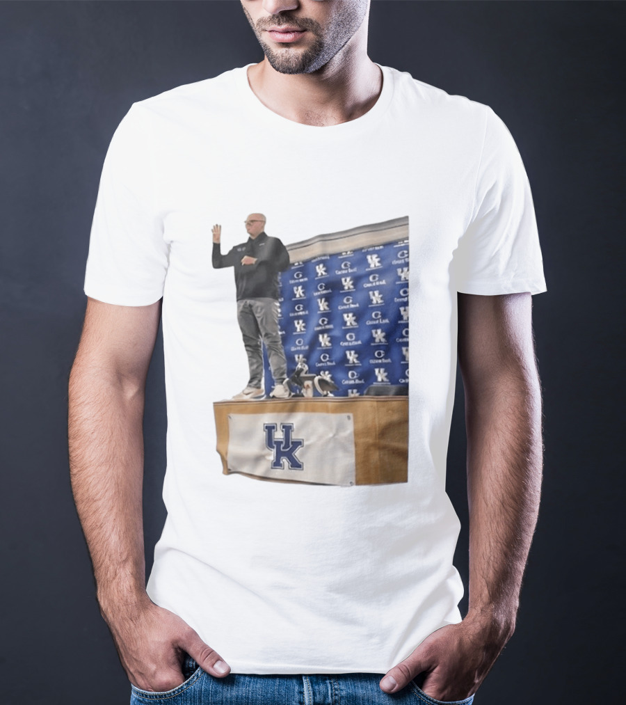 UK Volleyball Coach Craig Skinner Standing On Table With UK Logo And Awards T-Shirt