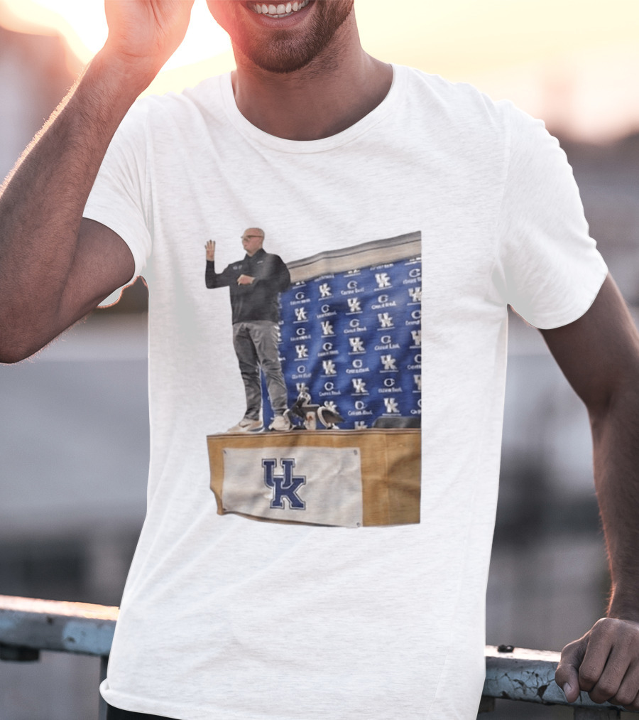 UK Volleyball Coach Craig Skinner Standing On Table With UK Logo And Awards T-Shirt