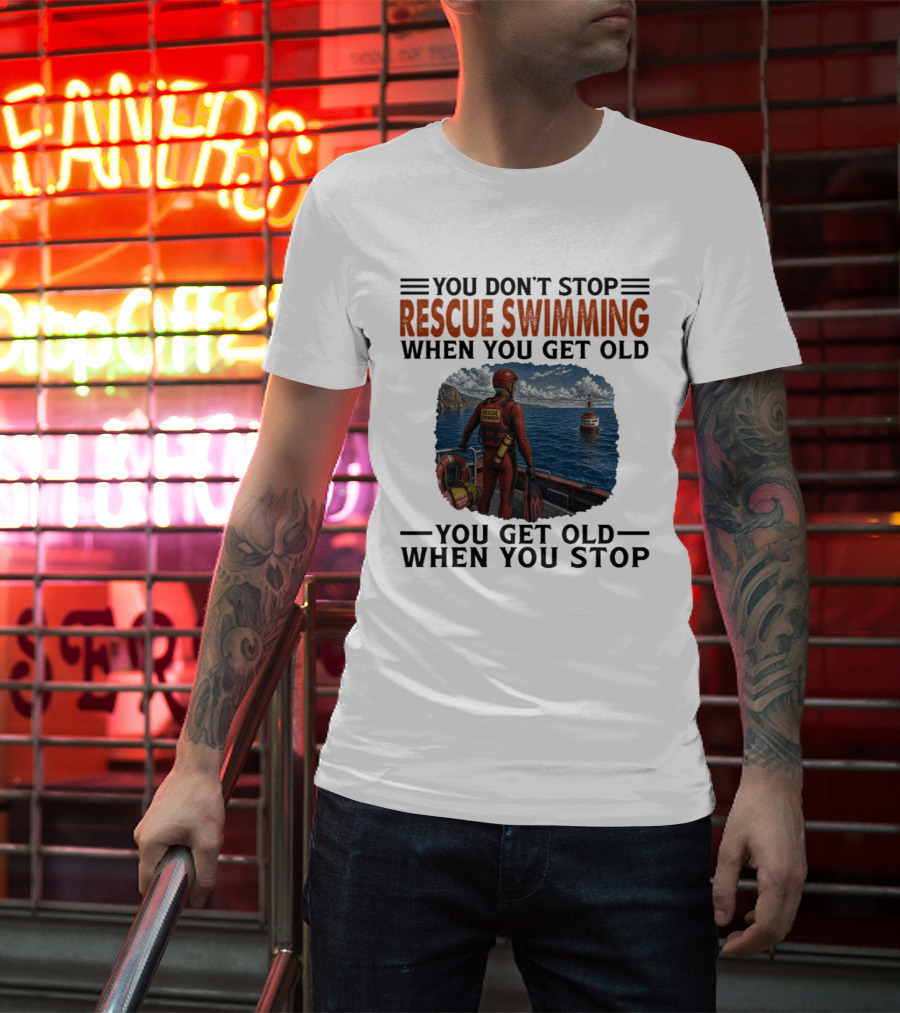 You Don't Stop Rescue Swimming When You Get Old You Get Old When You Stop Rescue Swimmer Standing On Boat Near Lighthouse T-Shirt