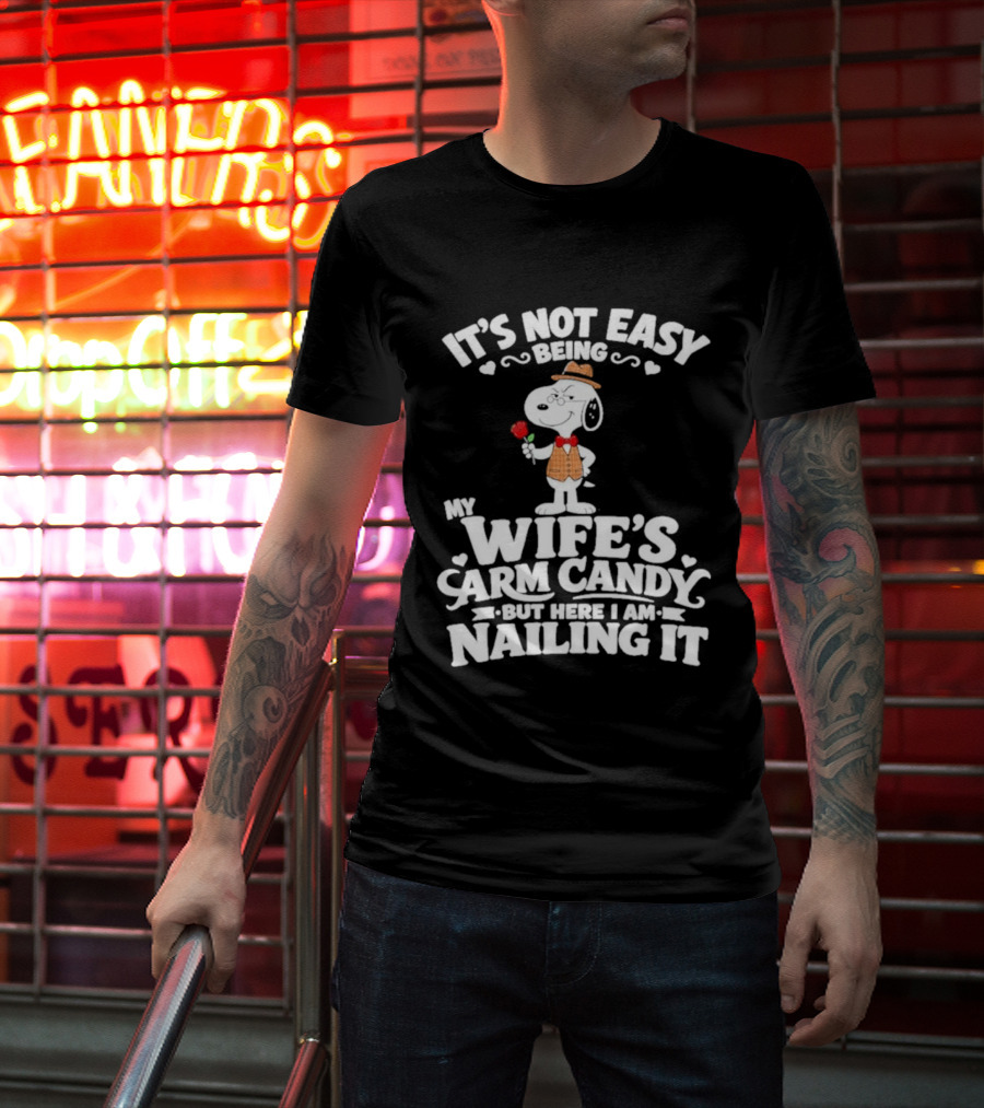Snoopy It's Not Easy Being My Wife's Arm Candy But Here I Am Nailing It T-Shirt