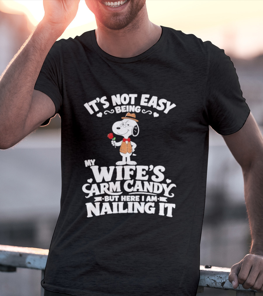 Snoopy It's Not Easy Being My Wife's Arm Candy But Here I Am Nailing It T-Shirt