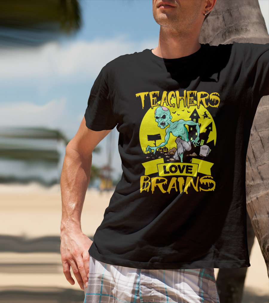 Teachers Love Brains Zombie Halloween Theme With Haunted Houses And Graveyard Background T-Shirt