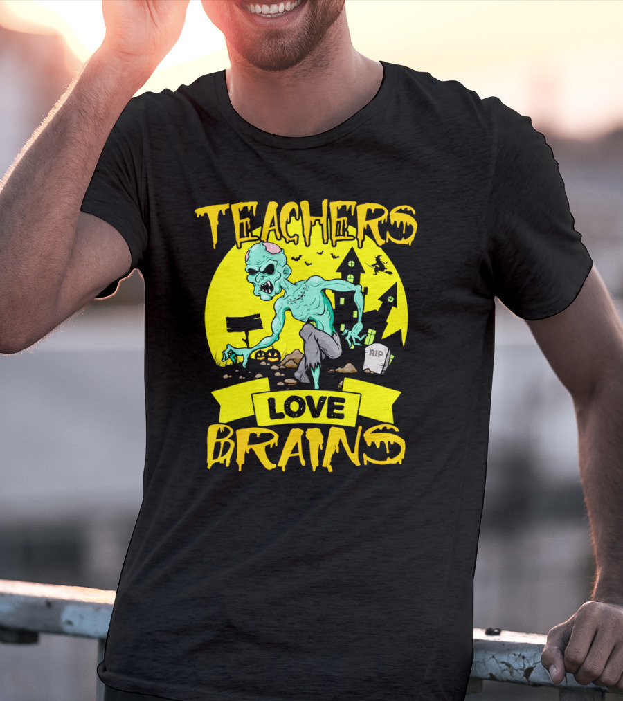 Teachers Love Brains Zombie Halloween Theme With Haunted Houses And Graveyard Background T-Shirt