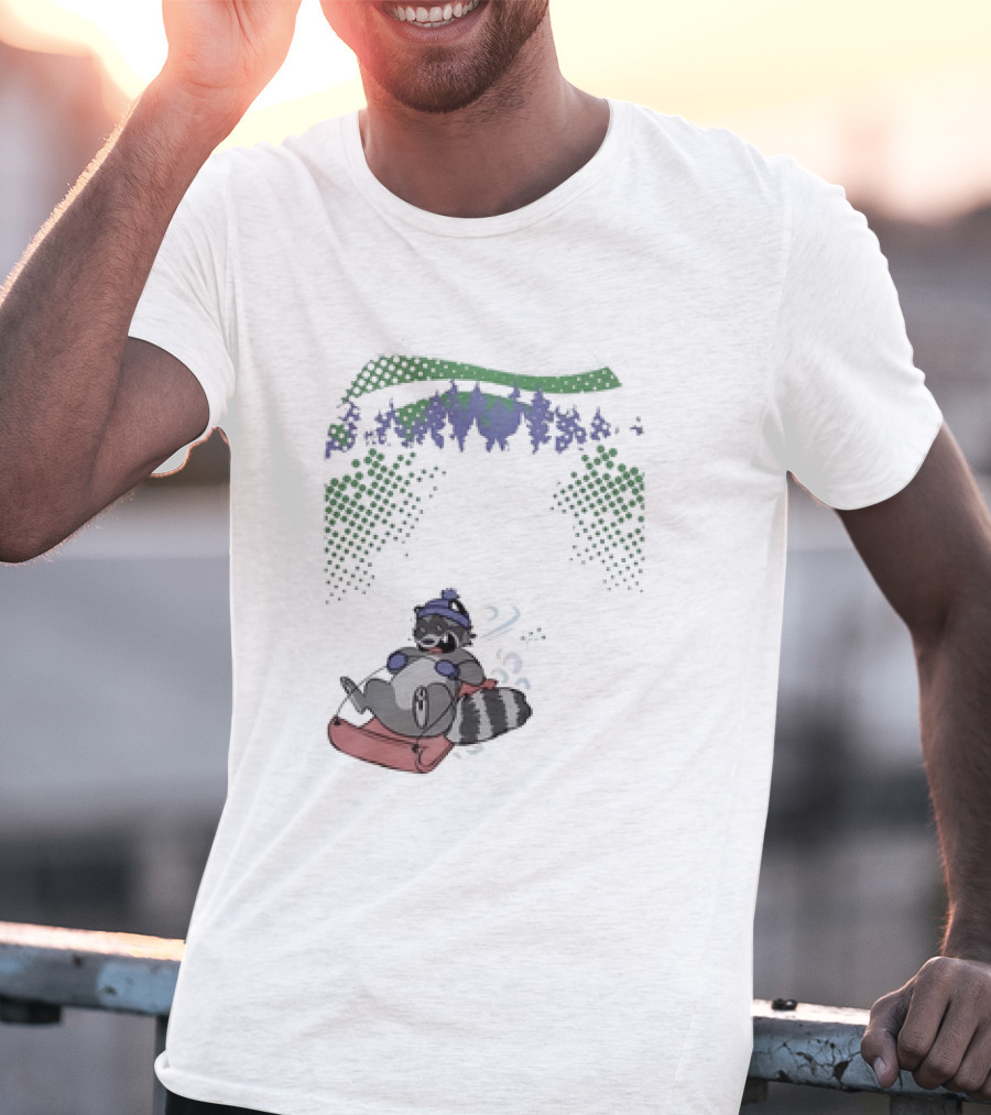 Raccoon Sledding In Winter Forest Scene With Evergreen Trees And Snowflakes T-Shirt