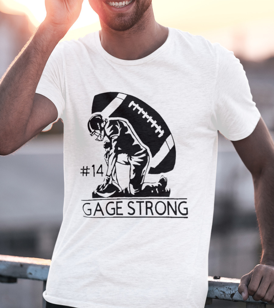 Gage Strong #14 Football Player Kneeling In Front Of Large Football T-Shirt