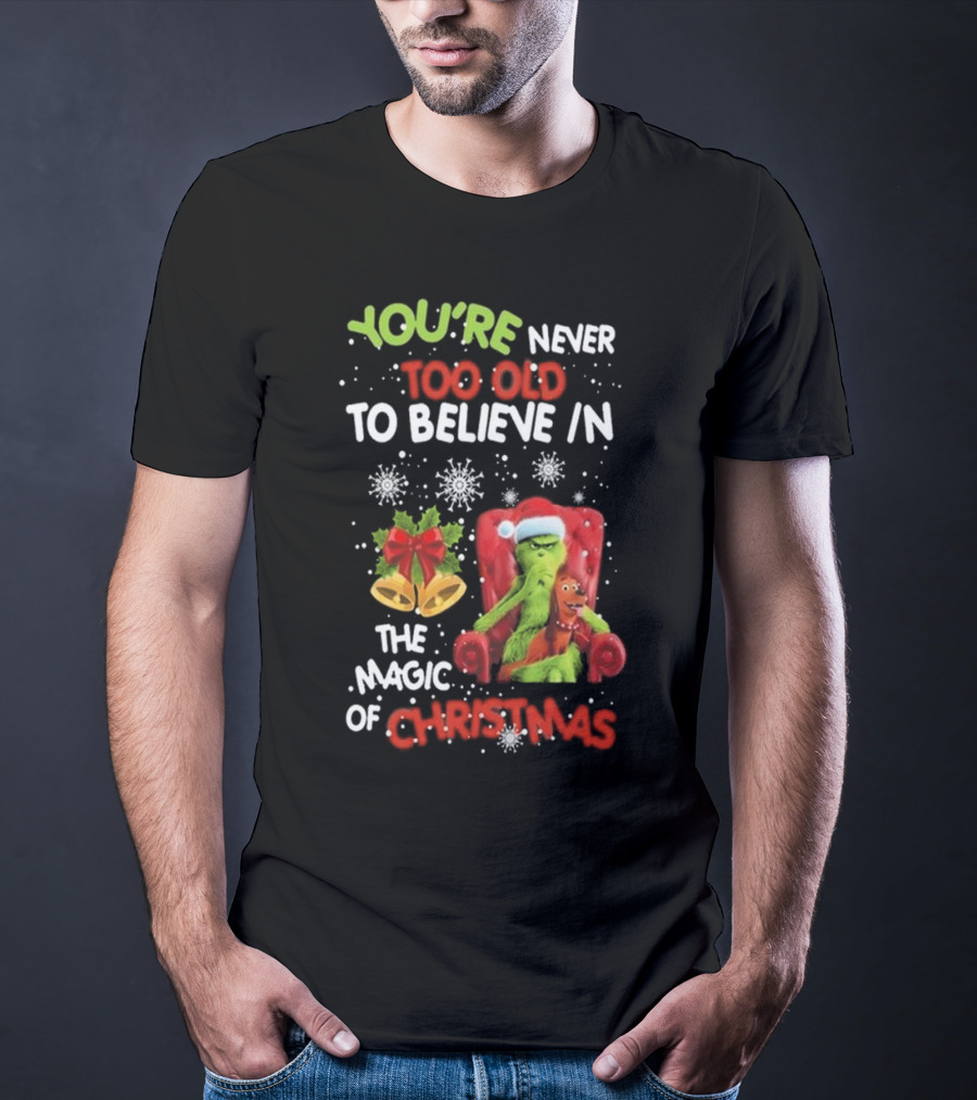 YOU'RE NEVER TOO OLD TO BELIEVE IN THE MAGIC OF CHRISTMAS GRINCH WITH MAX SITTING IN CHAIR SNOWFLAKES HOLIDAY BELLS AND BOW T-Shirt