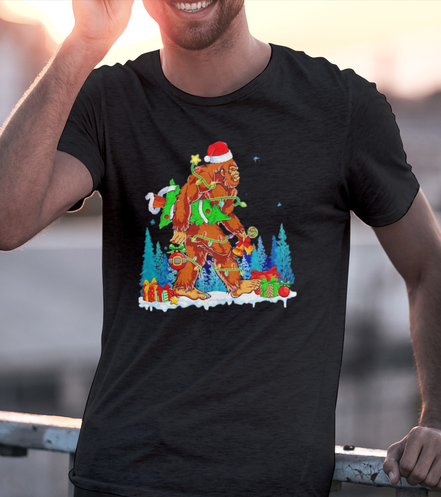 Bigfoot Santa Hugging Christmas Tree With Gifts And Snow Scene T-Shirt