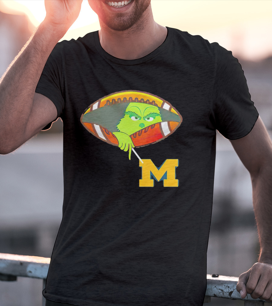 Grinch Peeking From Football Over Michigan Wolverines T-Shirt