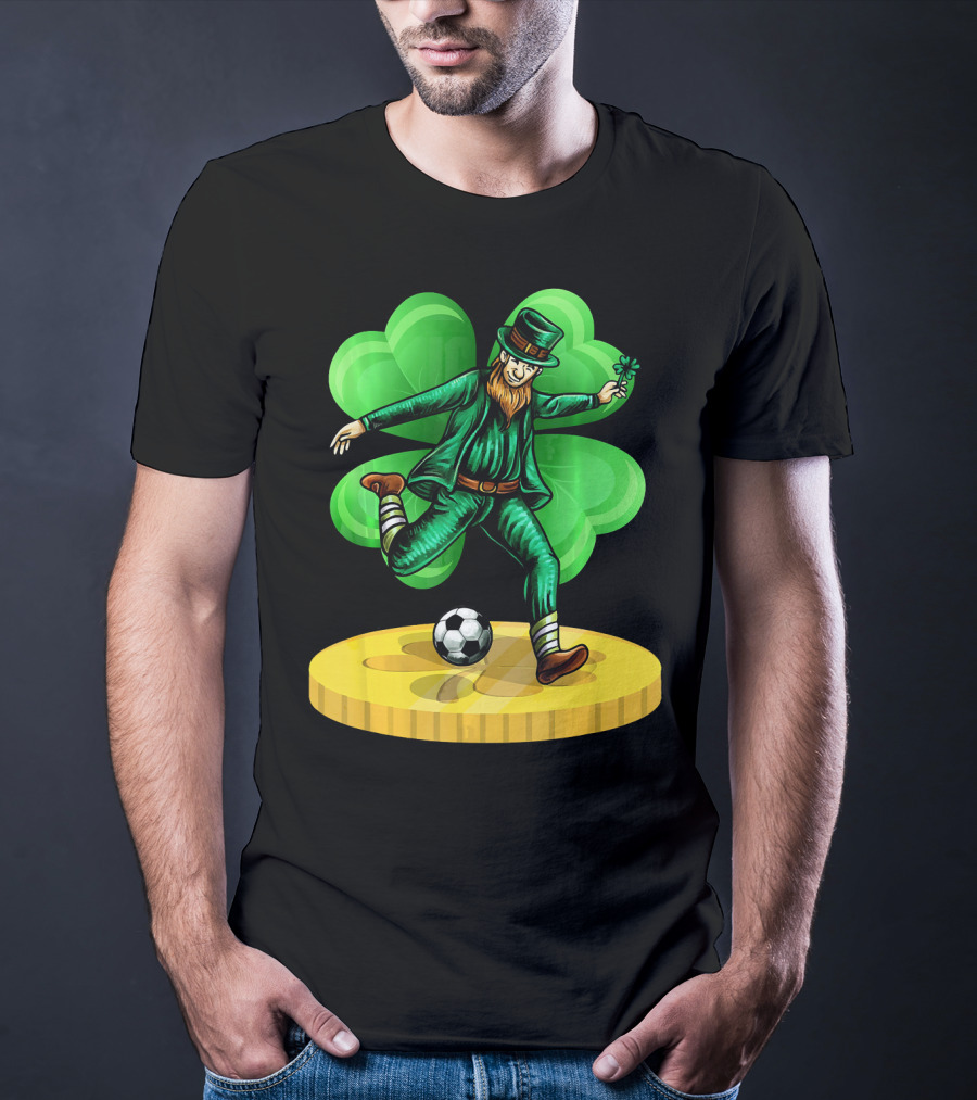 Leprechaun Kicking Soccer Ball On Gold Coin With Shamrock Background T-Shirt