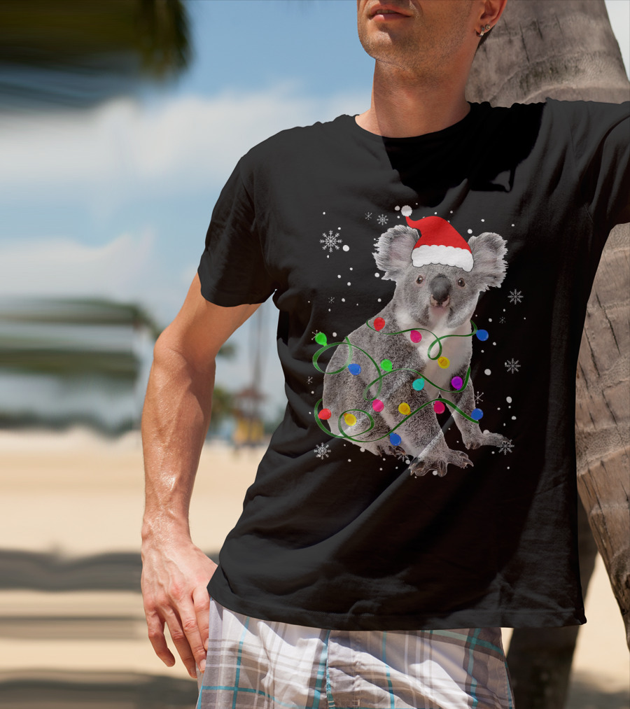 Koala Wrapped In Christmas Lights Wearing Santa Hat With Snowflakes Matching Fam T-Shirt