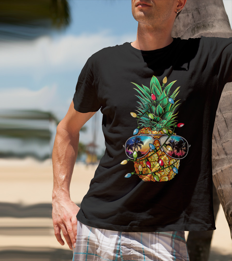 Pineapple Wrapped In Christmas Lights With Sunglasses Reflected Sunset And Palm Trees T-Shirt