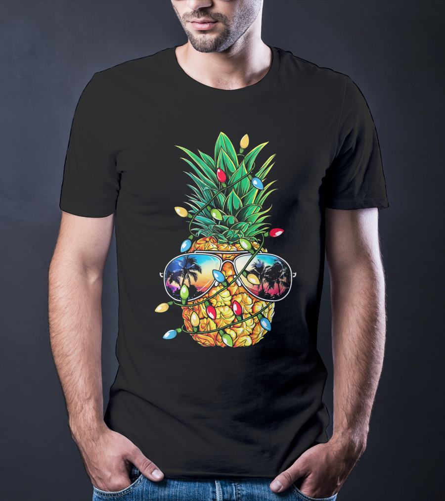 Pineapple Wrapped In Christmas Lights With Sunglasses Reflected Sunset And Palm Trees T-Shirt