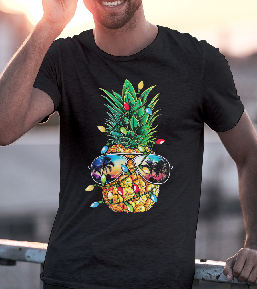 Pineapple Wrapped In Christmas Lights With Sunglasses Reflected Sunset And Palm Trees T-Shirt