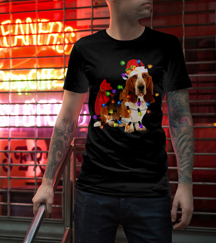Basset Hound Wrapped In Christmas Lights With Santa Hat And Red Sack T-Shirt