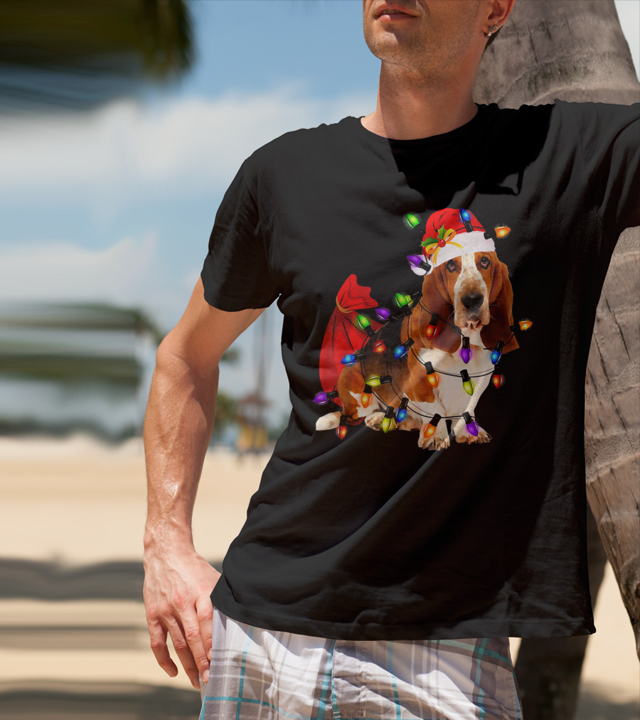 Basset Hound Wrapped In Christmas Lights With Santa Hat And Red Sack T-Shirt