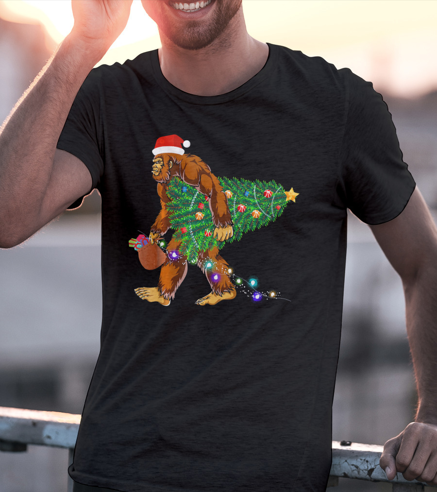 Santa Hat Bigfoot Holding Christmas Tree With Lights And Gifts T-Shirt
