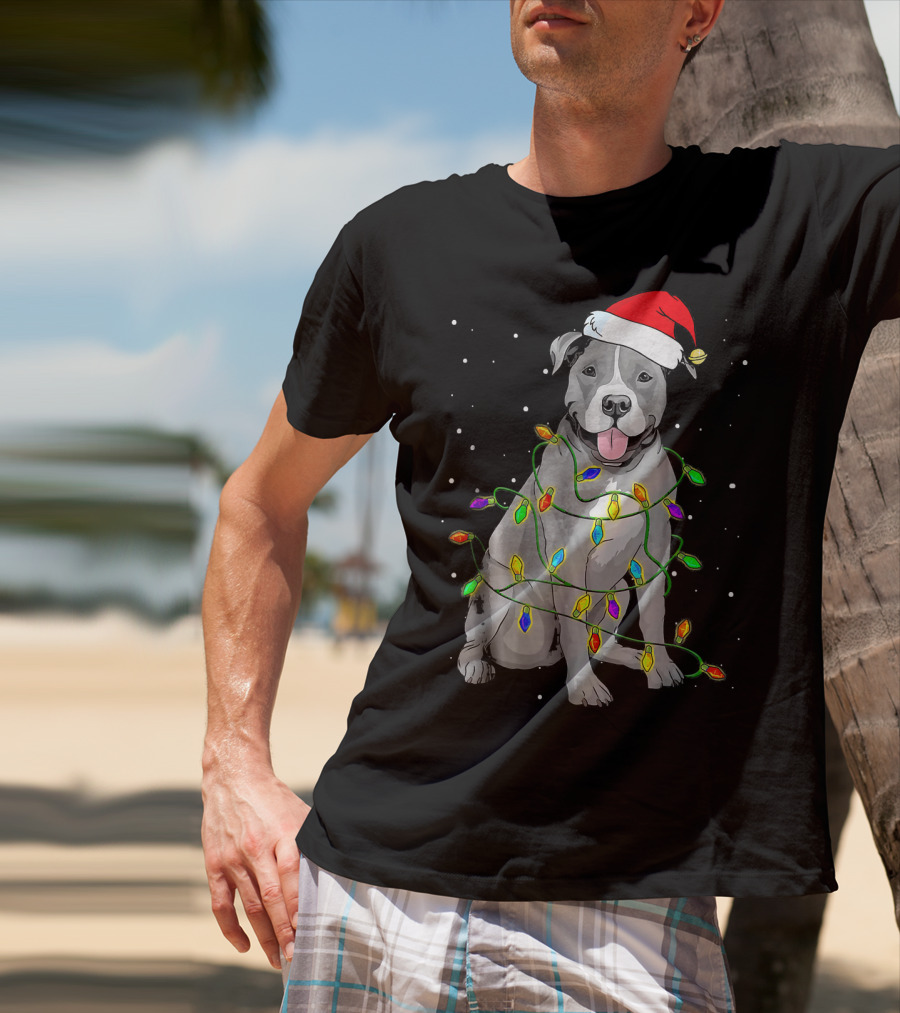 Pitbull In Santa Hat Wrapped In Christmas Lights With Snowy Background T-Shirt