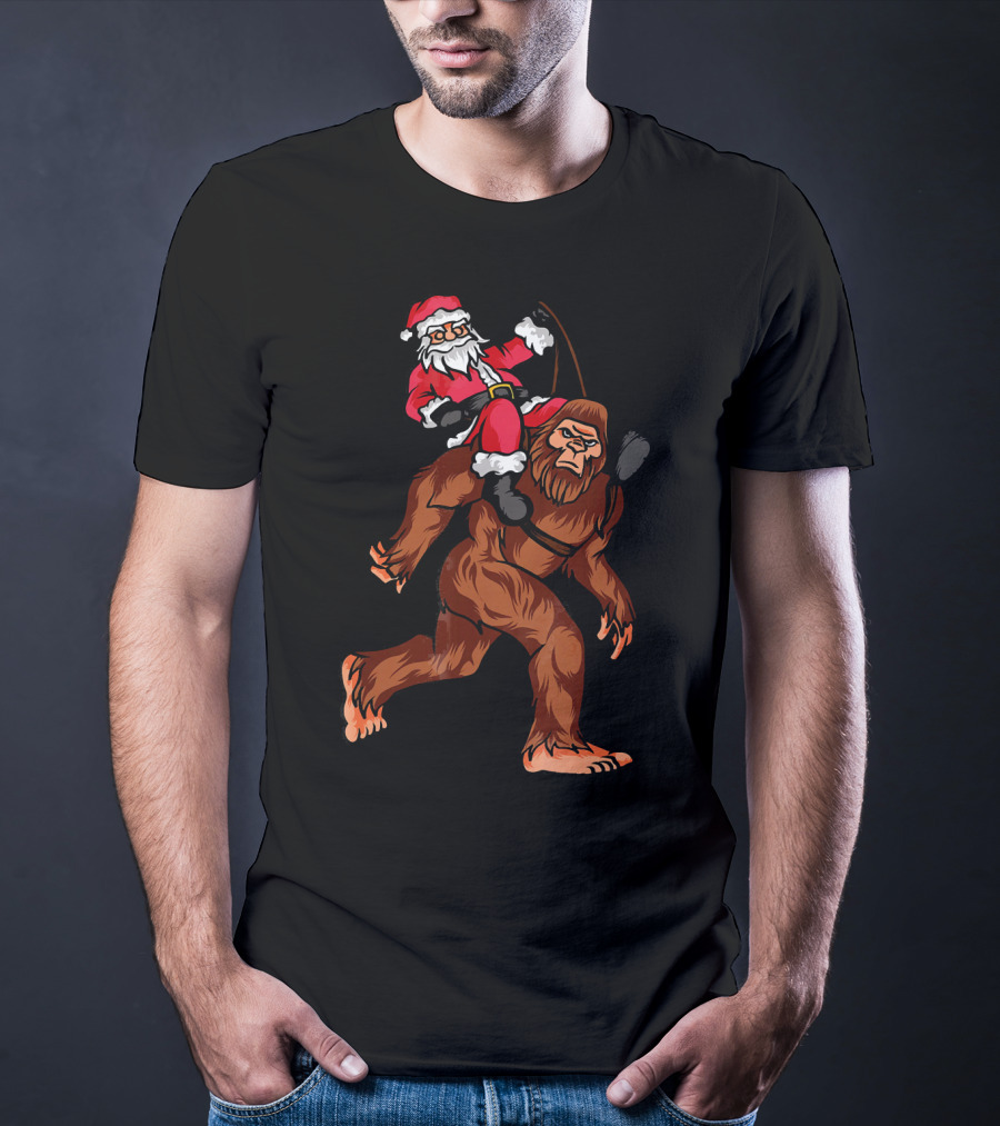 Bigfoot Carrying Santa Claus In Christmas T-Shirt